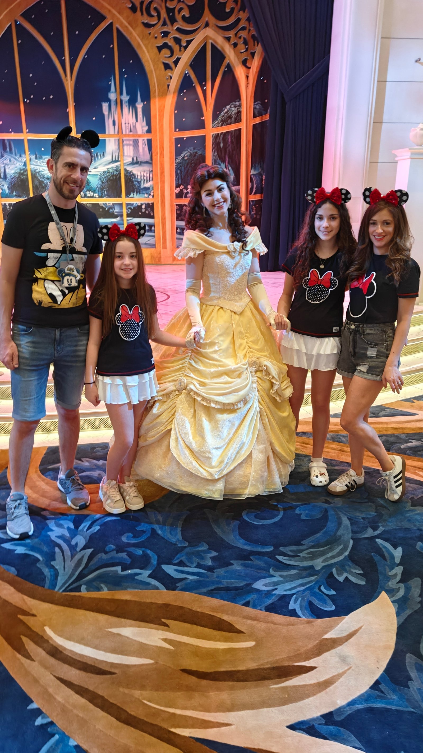 The Shoffmans pose with Belle aboard Disney Wish