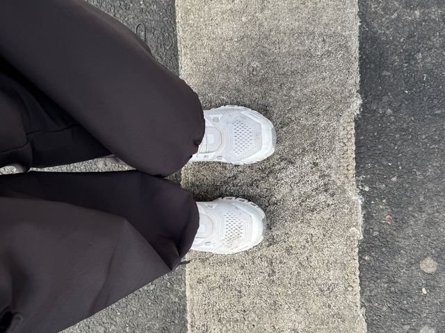 Image may contain: Road, Tarmac, Person, Walking, Clothing, Footwear, Shoe, Sneaker, Pants, and Adult