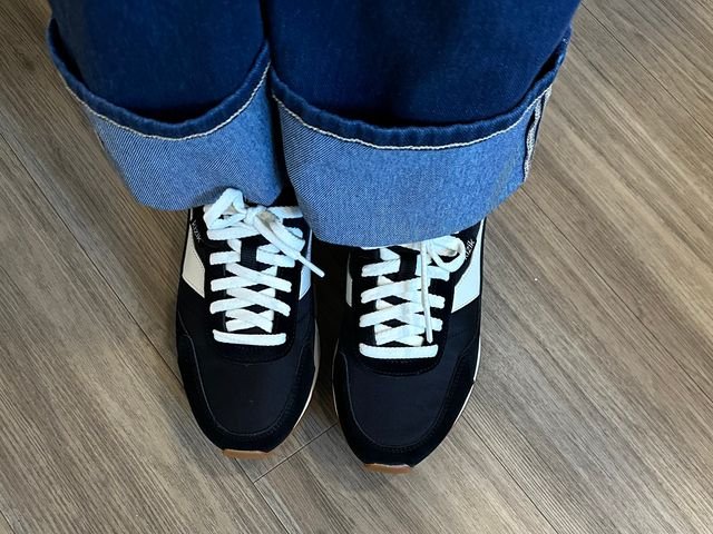 Image may contain: Clothing, Footwear, Shoe, Sneaker, Floor, Jeans, Pants, Hardwood, Wood, and Person