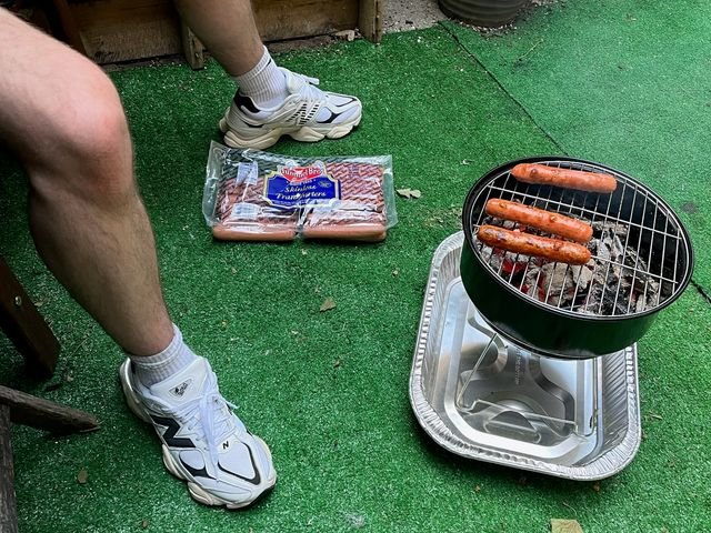 Image may contain: Plant, Bbq, Cooking, Food, Grilling, Person, Teen, and Hot Dog