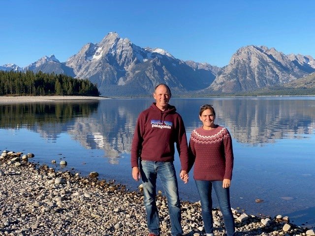 Richard and Jackie Pickles in front of a lake and mountains