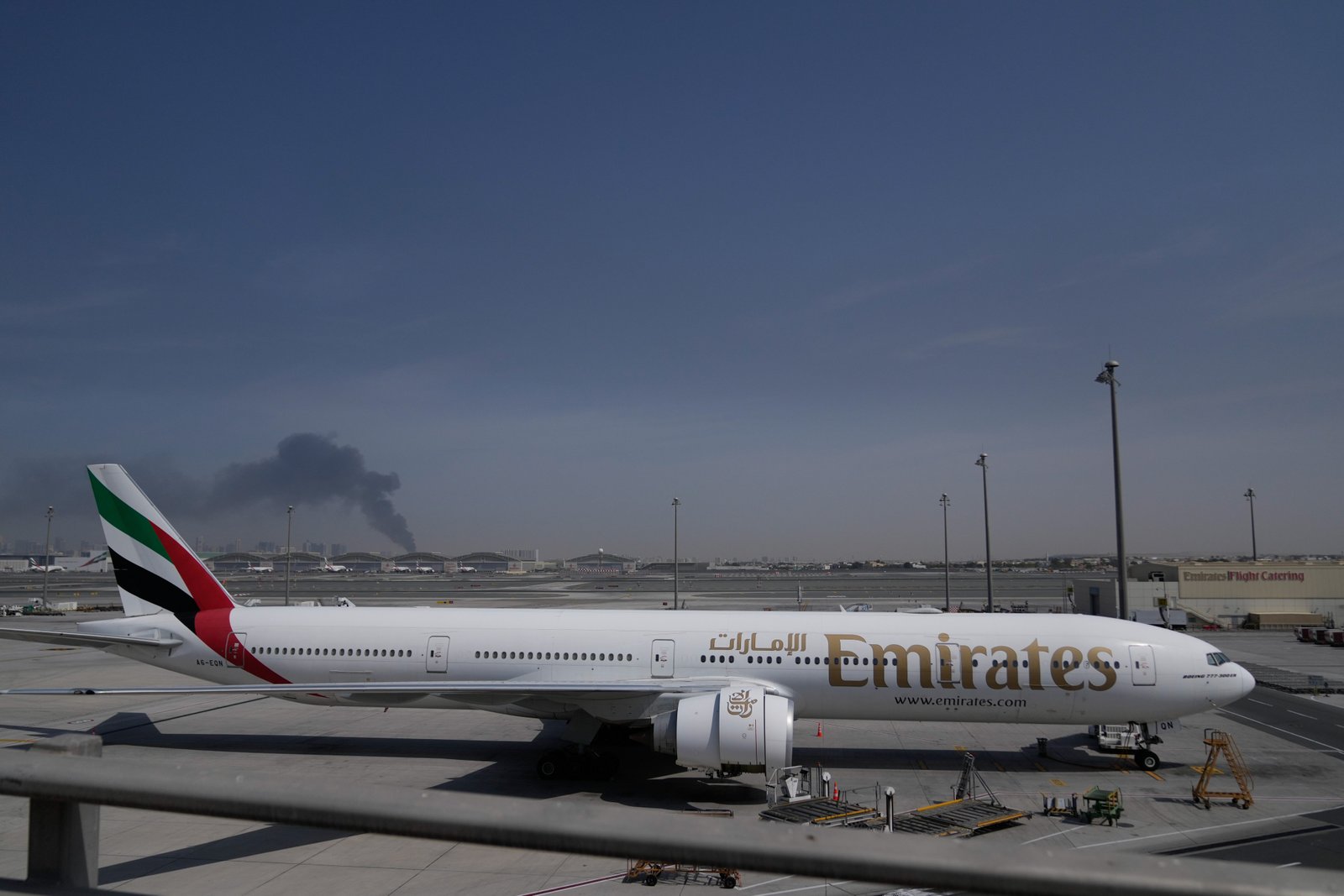 More than 12,000 flights have been canceled since U.S. air strikes were launched against Iran Saturday. An Emirates plane is seen at Dubai Airport on March 1, with a plume of smoke from an Iranian missile strike seen in the background