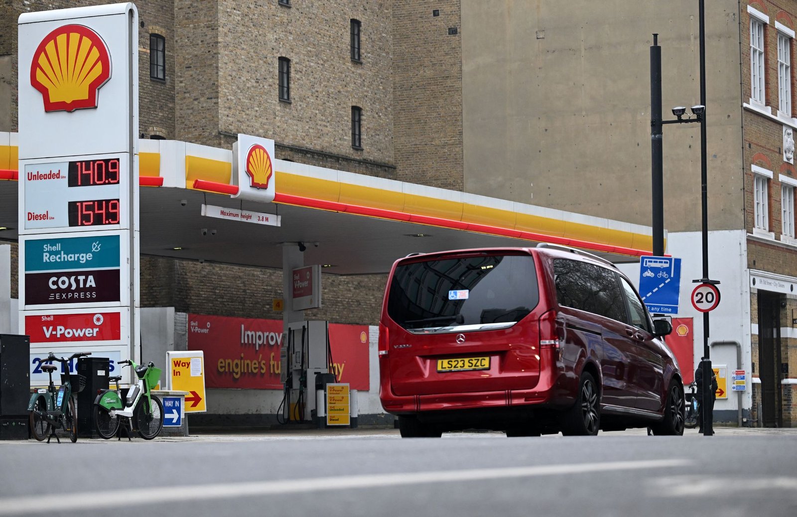 The price per litre of unleaded petrol and diesel fuels are pictured outside a Shell petrol station in east London, on March 9, 2026. Stock markets plunged Monday as oil and gas prices soared on fears about supplies from the Middle East with the US-Israeli war against Iran continuing into a second week with no sign of letting up. (Photo by Paul ELLIS / AFP via Getty Images)
