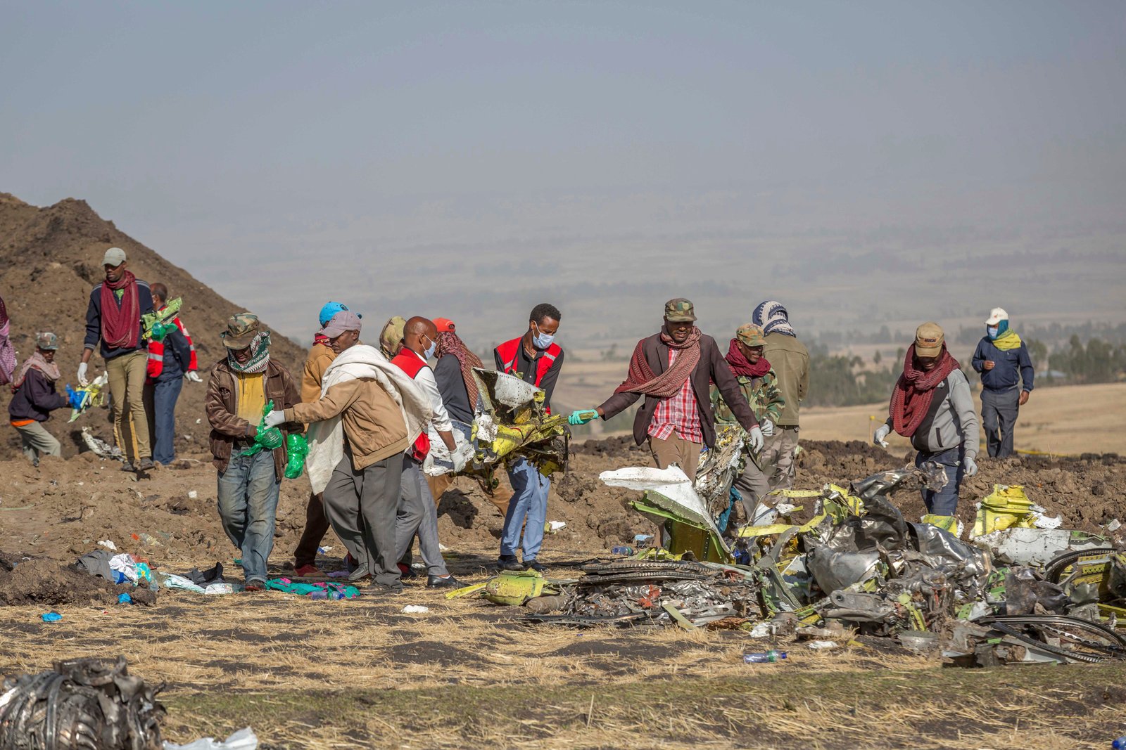 Rescuers work at the scene of an Ethiopian Airlines flight of a Boeing 737 Max 8 plane crash near Bishoftu, or Debre Zeit, south of Addis Ababa, Ethiopia.