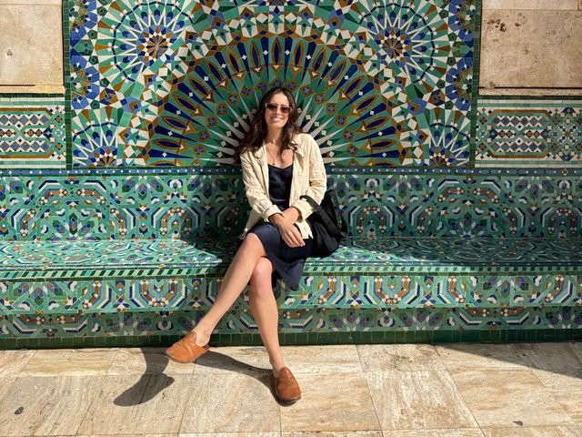 Image may contain: Tile, Clothing, Footwear, Shoe, Person, Sitting, Adult, Accessories, Glasses, Bag, Handbag, and Art