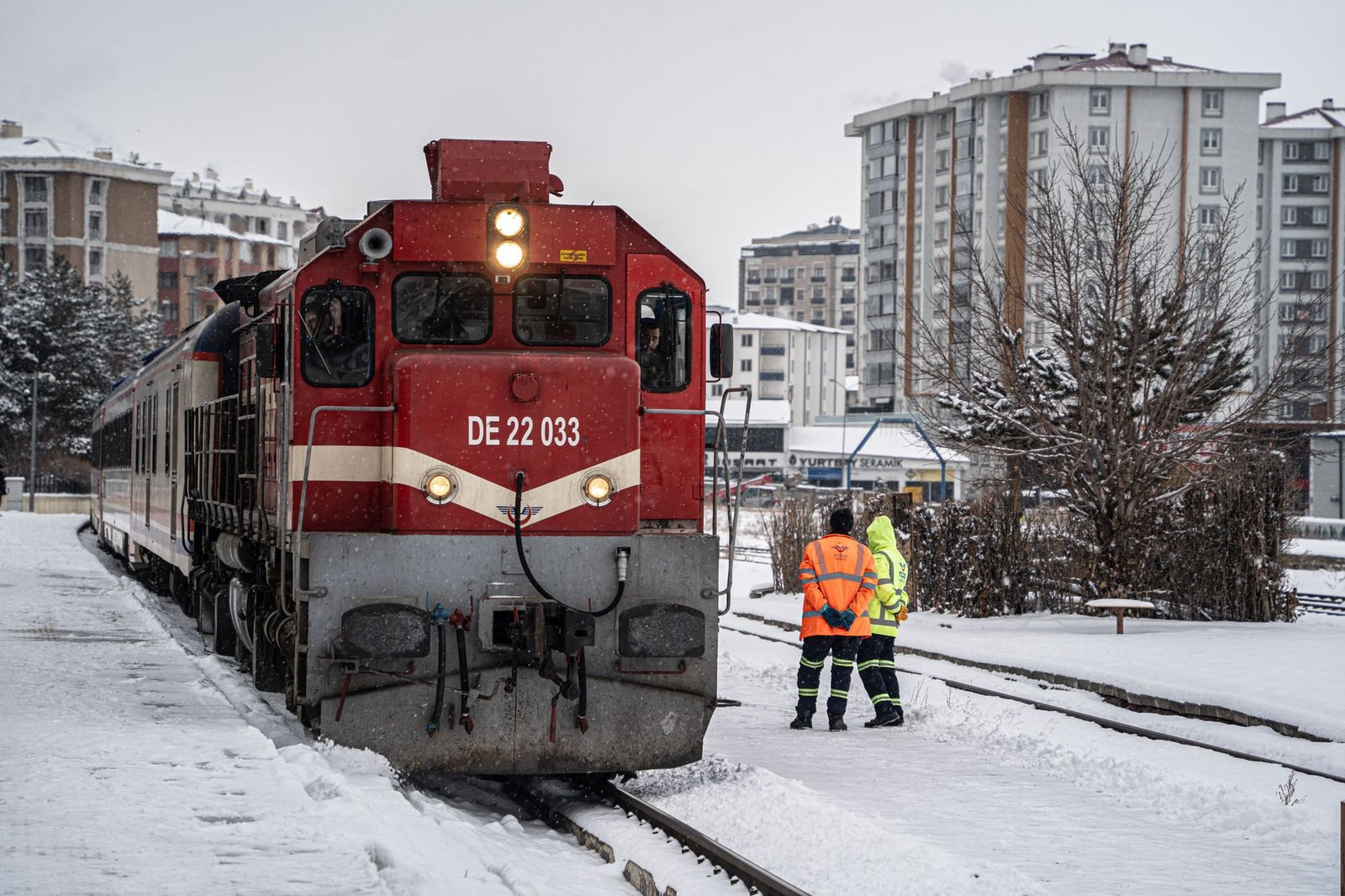 The train winds through snowy landscapes and parched plateaus