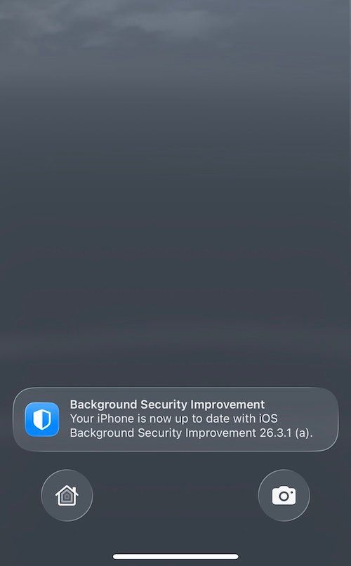 a screenshot showing an iPhone home/lock screen after a restart. A notification reads: "Background Security Improvement Your iPhone is now up to date with ioS Background Security Improvement 26.3.1 (a)."