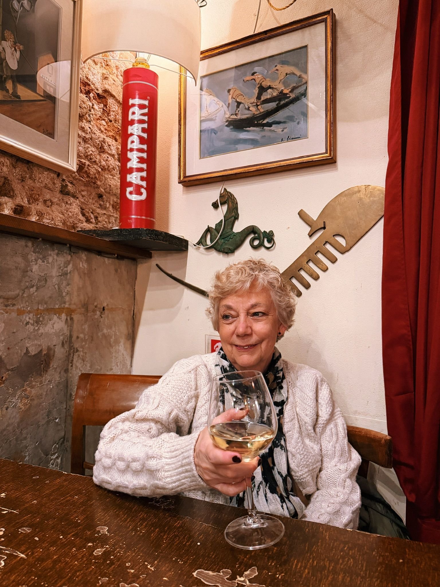 Image may contain Adult Person Sitting Furniture Table Glass Face Head Photography Portrait Sword and Weapon