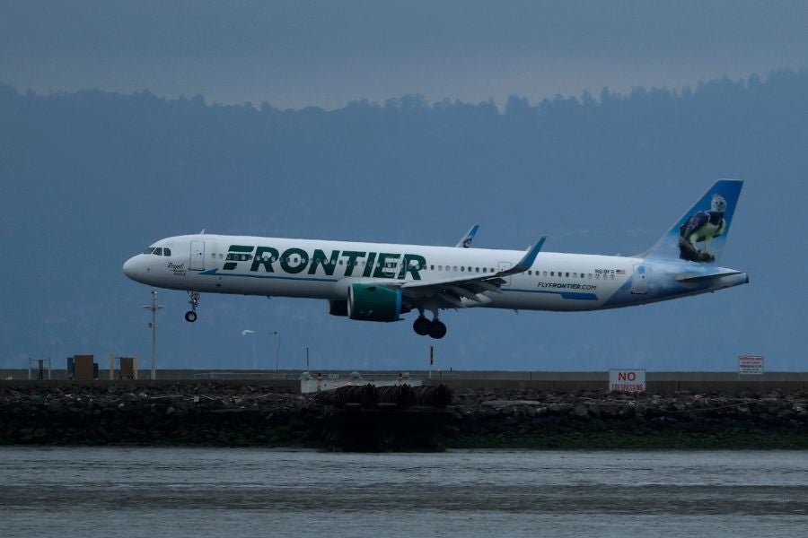 A Frontier Airlines passenger is in custody after allegedly threatening to kill his seatmate and declaring that he had a bomb on board a flight that had just landed in Atlanta