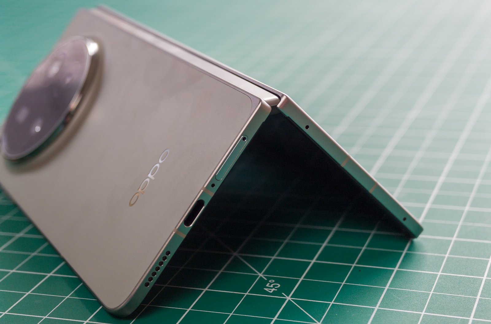 Photo of Oppo Find N6 on a green work mat in a tented position