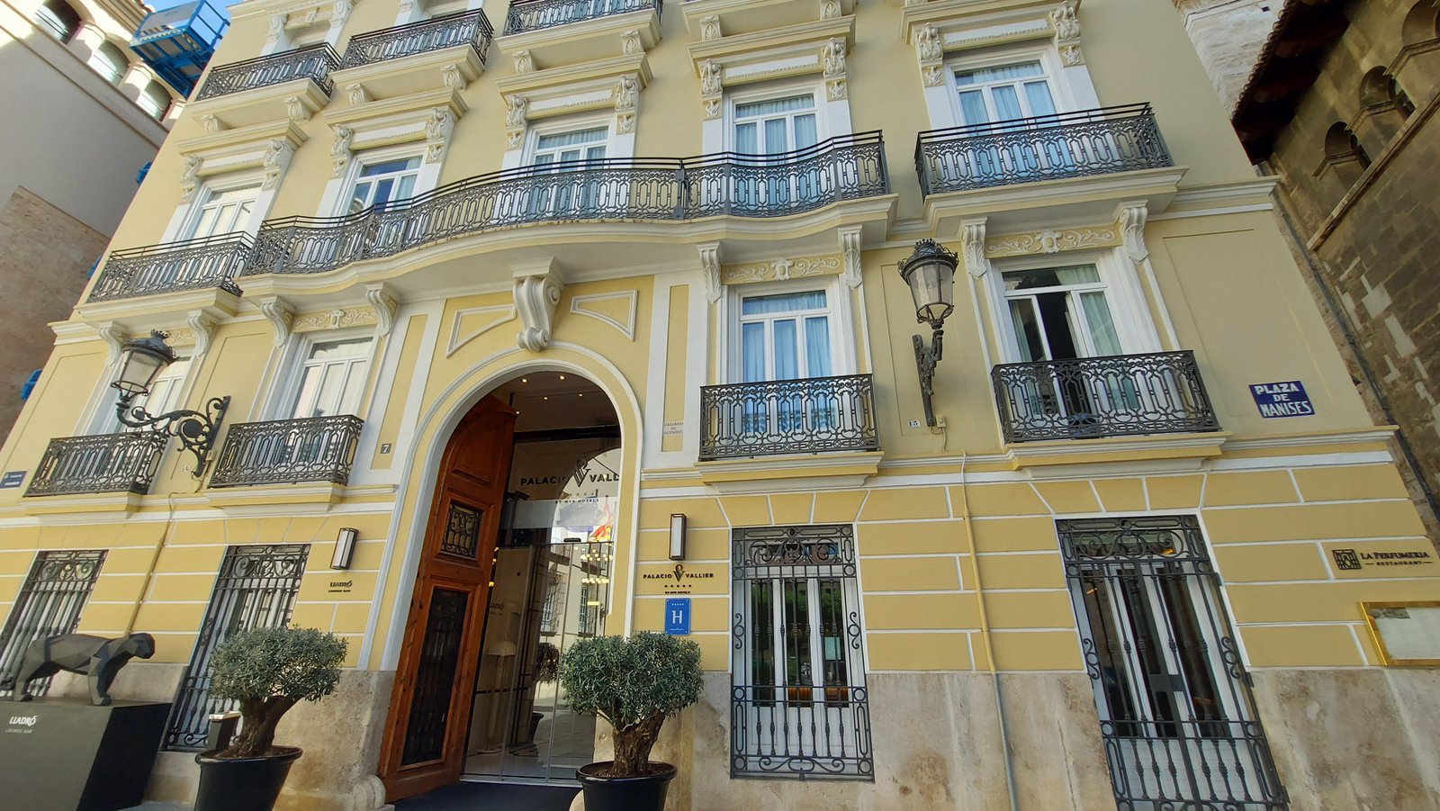 Palacio Vallier has a buttery yellow facade embellished with wrought-iron balconies