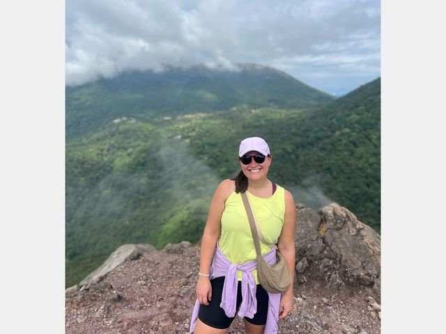 Image may contain: Adventure, Hiking, Leisure Activities, Nature, Outdoors, Person, Head, Face, Accessories, Bag, and Handbag