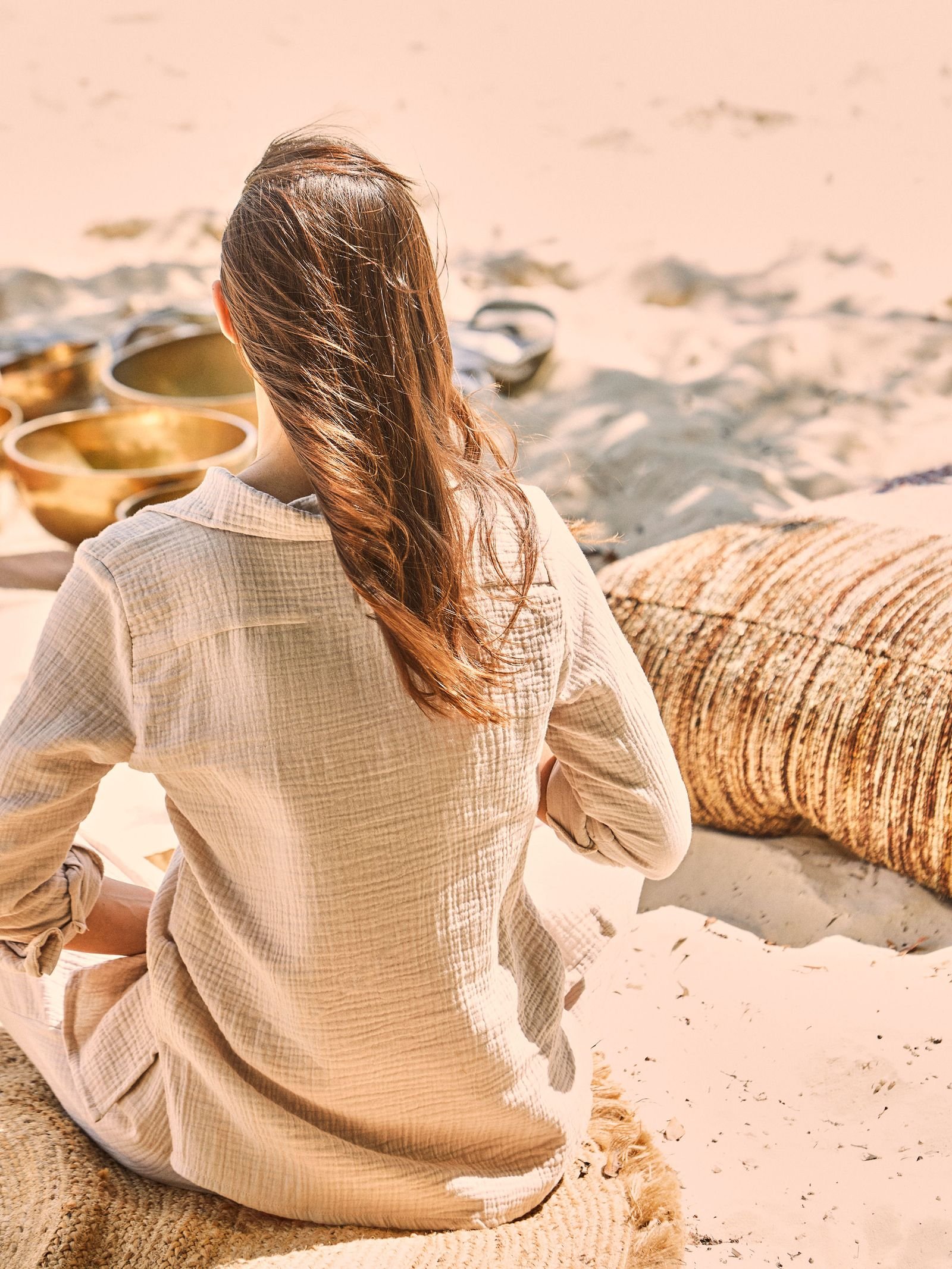 Image may contain Adult Person Sitting Beachwear Clothing Hair and Sleeve