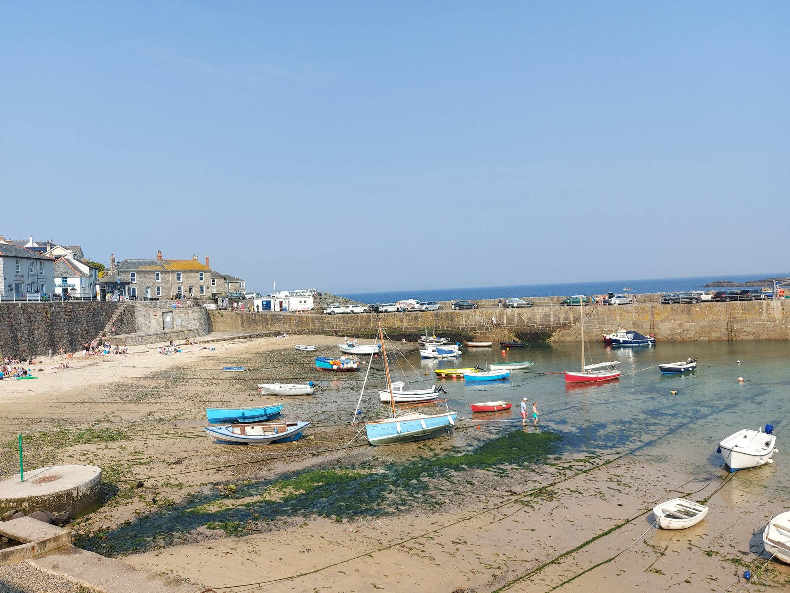 Mousehole Harbour in the south of Cornwall reveals a sandy stretch when the tide is out