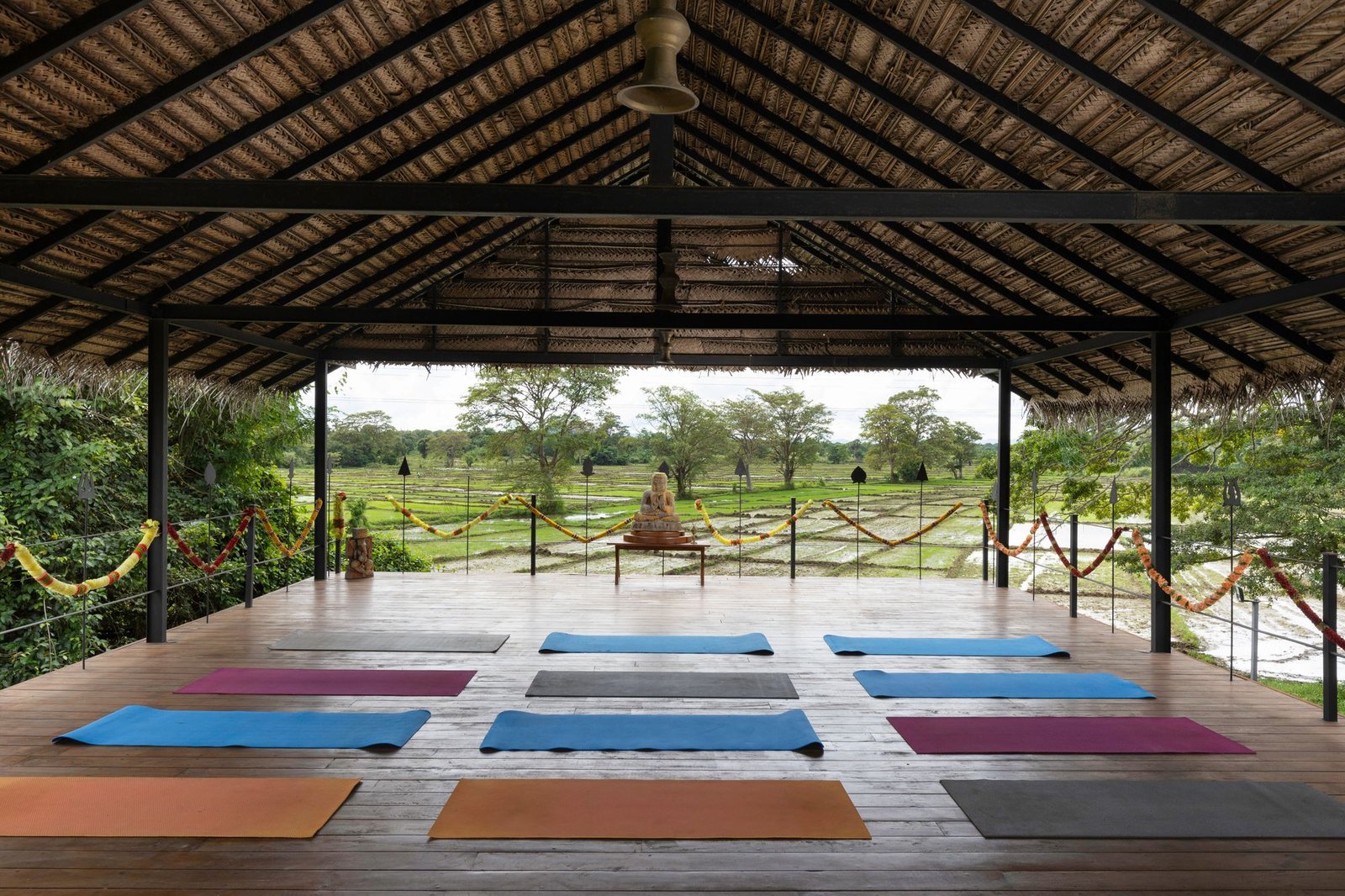 The open-sided yoga studio at Ayurvie Sigiriya in Sri Lanka overlooks the rice paddies